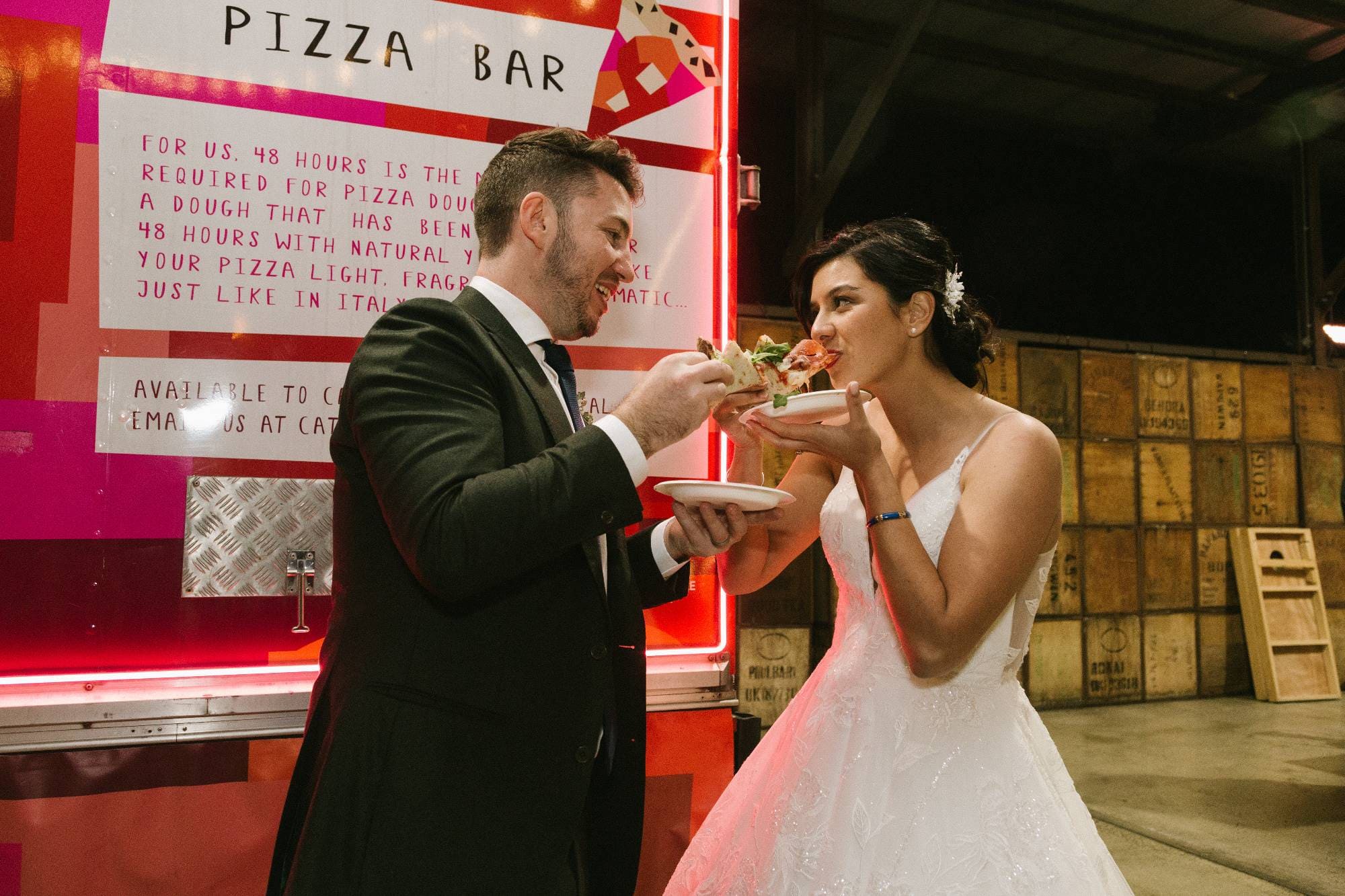 A newlywed eating a delicious pizza together